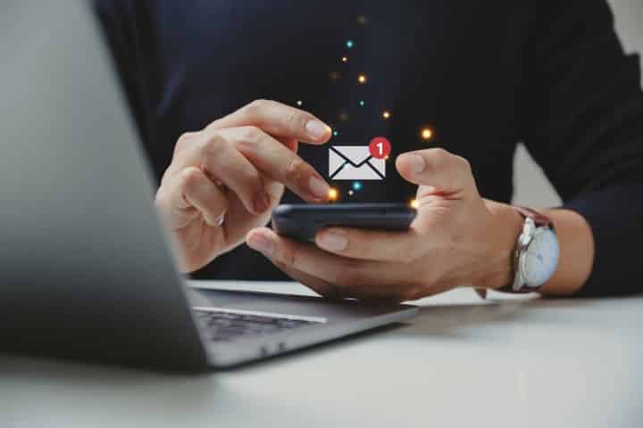 Hand of businessman using smartphone for email with notification